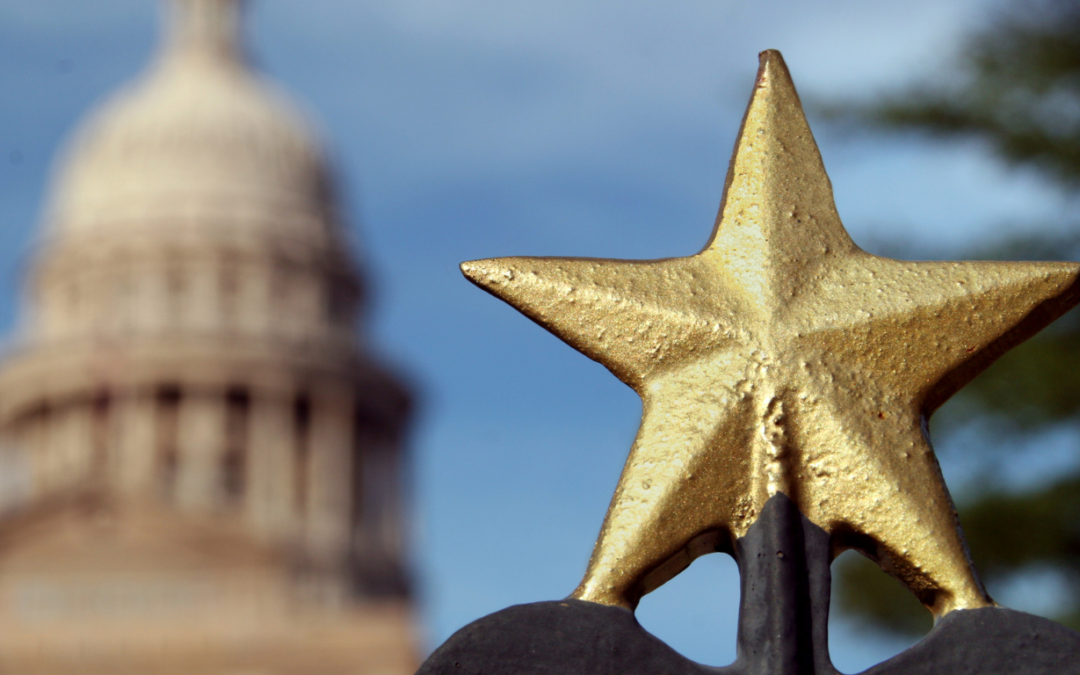 Gold texas star fence post in foreground with blurred image of Texas capitol in background